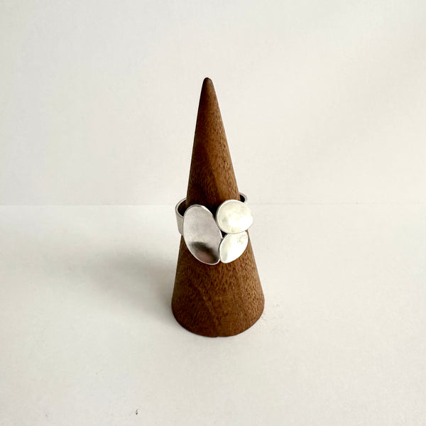 Front view of three ovals ring on a wooden ring holder. www.wyckoffsmith.com