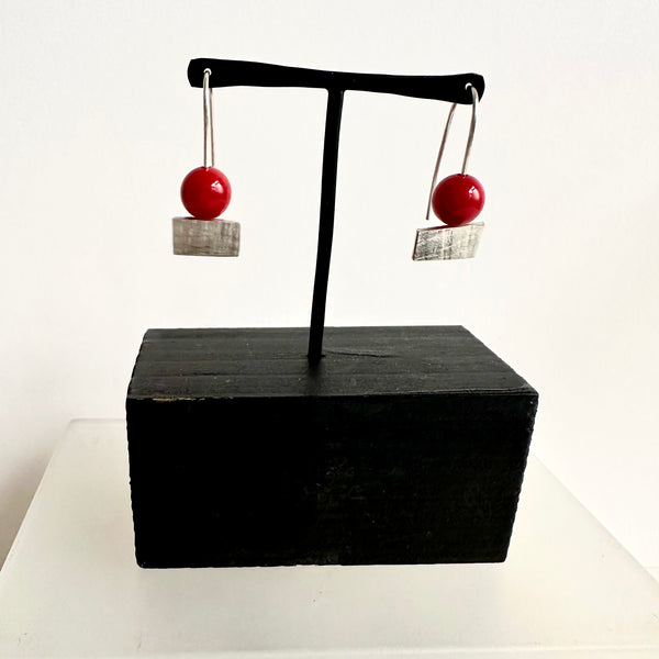 Dyed red jade bead on top of a textured rectangle dangle earring. www.wyckoffsmith.com