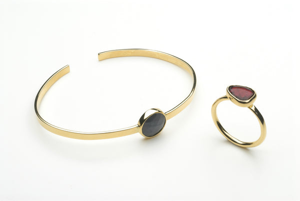 Pink tourmaline ring and blue grey sapphire cuff by Michele Wyckoff Smith.
