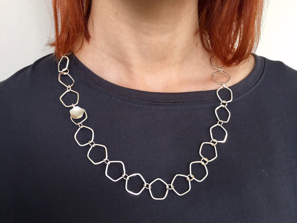 Open Calyx silver chain with hammered texture and easy clasp.