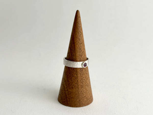 Tudor set ruby in a Tudor setting shown on a wooden cone - www.wyckoffsmith.com