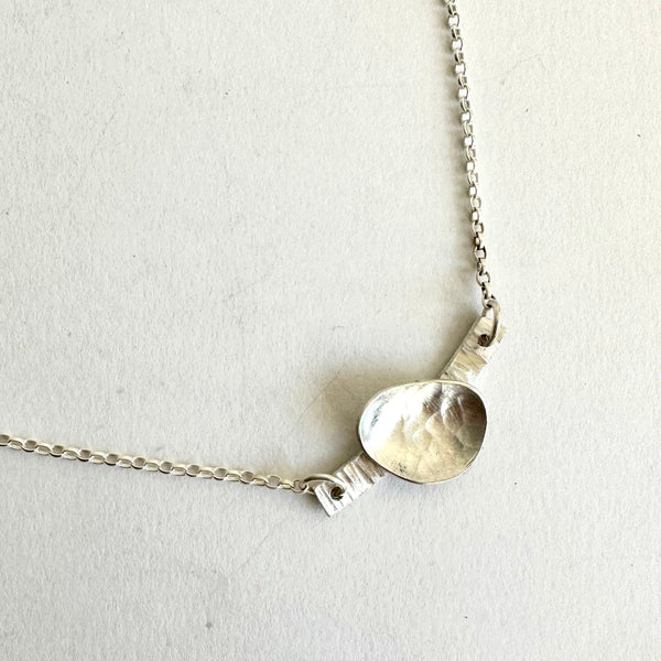 Side view of oval pendant on adjustable silver belcher chain - www.wyckoffsmith.com