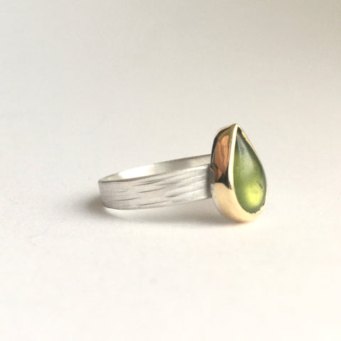 Side view of pear shaped green idiocrase vesuvianite stackinging ring set in 18 ct gold on a silver textured band on www.wyckoffsmith.com. Perfect for a volcanologist