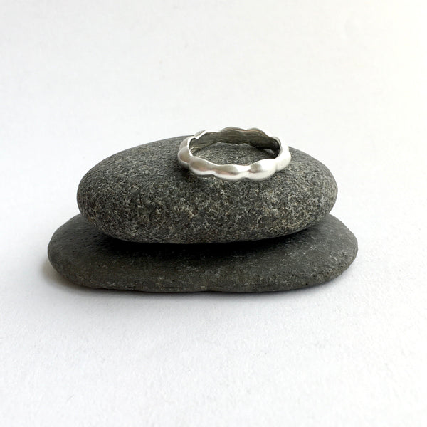 Top view of Kelp Ring on top of two stones available on www.wyckoffsmith.com