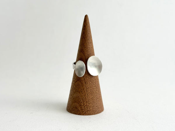 Front view of adjustable ring with two matte oval shape on a wooden ring holder - www.wyckoffsmith.com