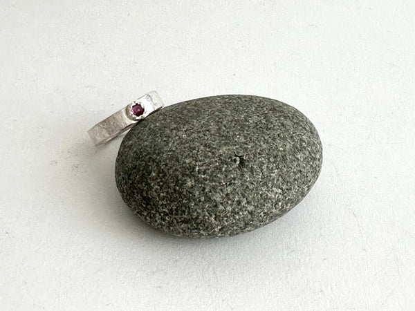 Inverted ruby in a Tudor Setting on a rough hammered silver band - www.wyckoffsmith.com