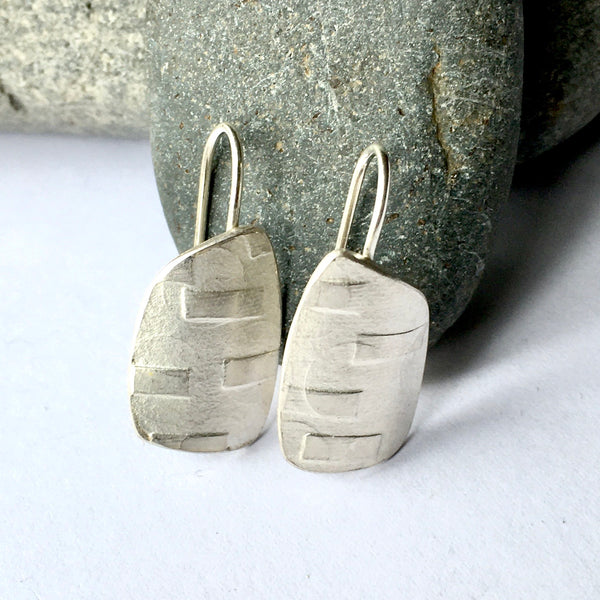 Horizontal sliding bar texture on asymmetrical spinnaker silver earrings (option 2) on www.wyckoffsmith.com