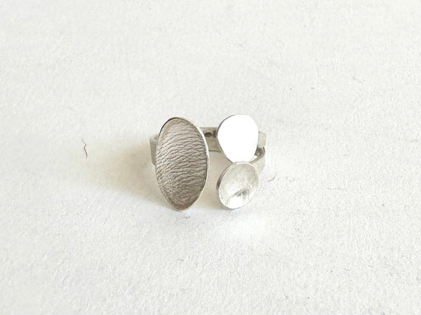 Small adjustable ring with three oval designs - front view - www.wyckoffsmith.com
