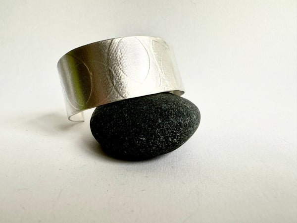 Oval leaf textured silver cuff on pebble - www.wyckoffsmith.com