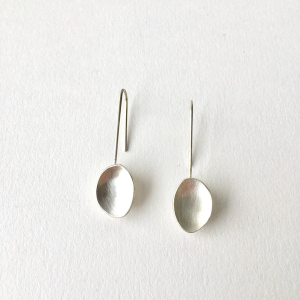 Organic shaped oval dangling earrings by Wyckoff Smith Jewellery.