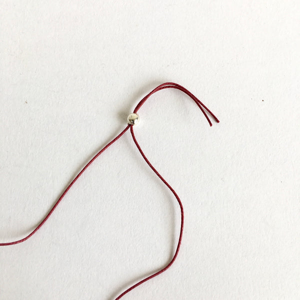 detail of red thread with silver ball - www.wyckoffsmith.com