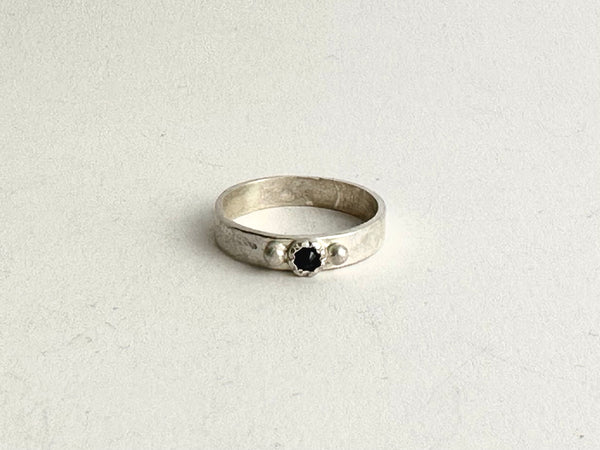 Front view of tudor set sapphire on wide silver band - www.wyckoffsmith.com
