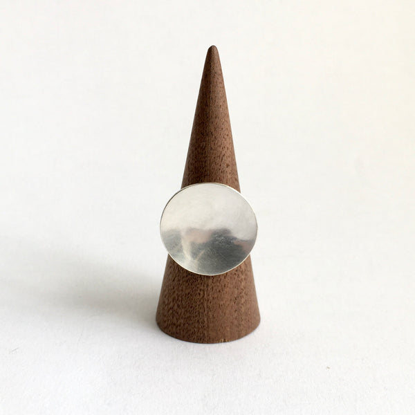 Concave circular ring on wooden ring stand - www.wyckoffsmith.com - full moon statement ring
