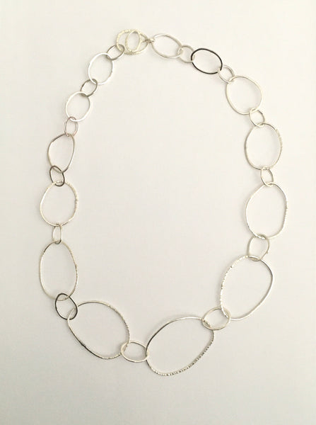 Long view of organic shaped silver pebble chain on www.wyckoffsmith.com