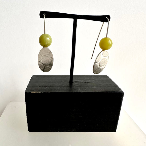 Lemon quartz round bead on top of a silver textured elongated oval dangle earring. www.wyckoffsmith.com
