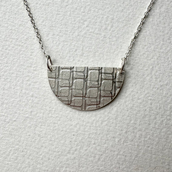 Front view of silver half moon shaped textured pendant on adjustable chain - Love Letter pendant - www.wyckoffsmith.com - Michele Wyckoff Smith