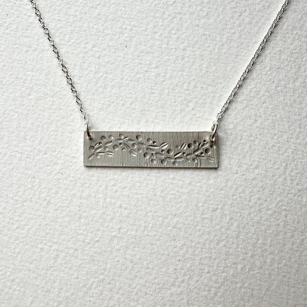 Front view of garland patterned silver pendant on embossed silver with adjustable silver chain - www.wyckoffsmith.com  - Michele Wyckoff Smith