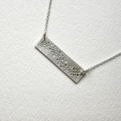 garland pattern on a bar shaped silver pendant with adjustable chain - www.wyckoffsmith.com - Michele Wyckoff Smith