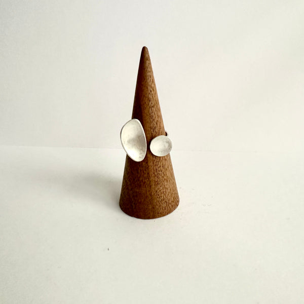 Front view of contrasting silver oval and circle on a wooden cone. Hand punched textured ring shank. www.wyckoffsmith.com
