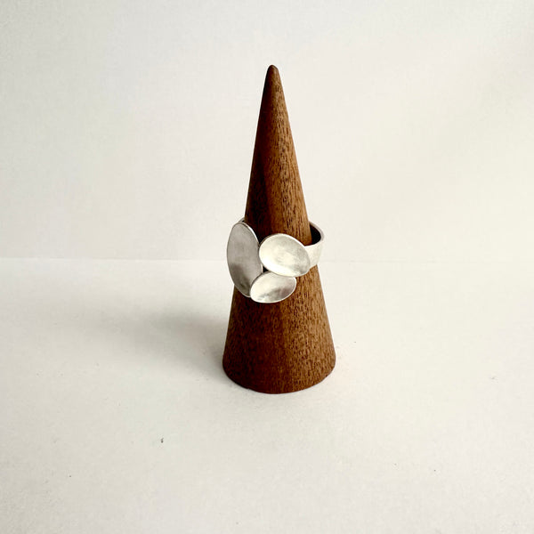 Triple oval open ring  on a wooden cone. www.wyckoffsmith.com