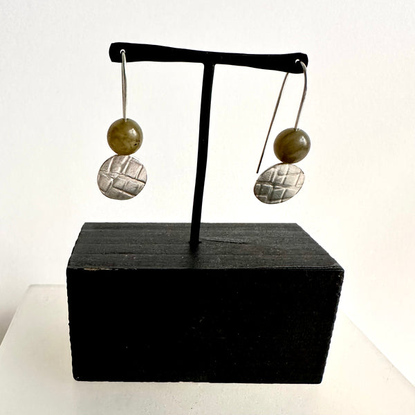 Grey labradorite round bead on top of textured silver circle dangle earring. www.wyckoffsmith.com