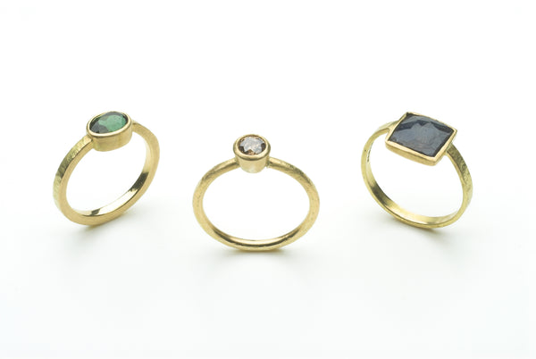 Green tourmaline ring, mauve diamond ring and square faceted lapis lazuli gold rings by Michele Wyckoff Smith.