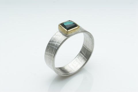 Square tourmaline in 18 ct gold with textured silver band.