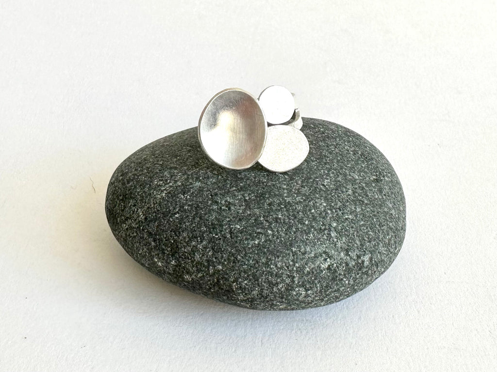 Three oval shapes on an adjustable ring sitting on a pebble - www.wyckoffsmith.com