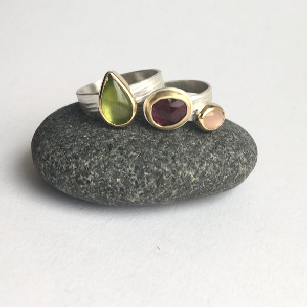 Three stacking rings by Michele Wyckoff Smith on www.wyckoffsmith.com left to right: green vesuvianite (idiocrase), deep pink tourmaline and peach moonstone