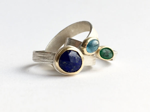 Jumble of silver and gold stacking rings by Michele Wyckoff Smith: gold flecked lapis lazuli, tourmaline and rough emerald