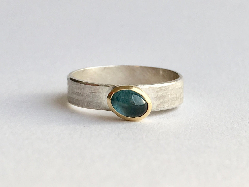Oval tourmaline set in 18 ct gold on textured silver 4.75 mm wide band by Michele Wyckoff Smith