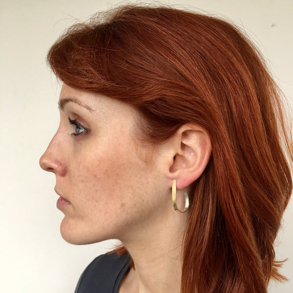 Model wearing textured silver modern minimalist hoop earring by Michele Wyckoff Smith