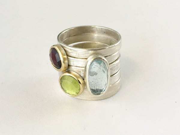 Stacking gemstone rings by Michele Wyckoff Smith - garnet, peridot and blue topaz gemstone rings sold separately on www.wyckoffsmith.com