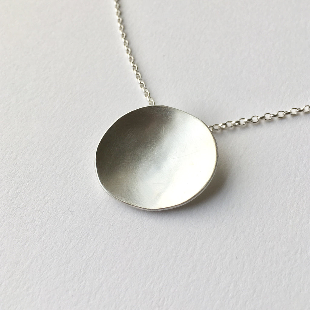 Organic shape oval silver pendant by Michele Wyckoff Smith