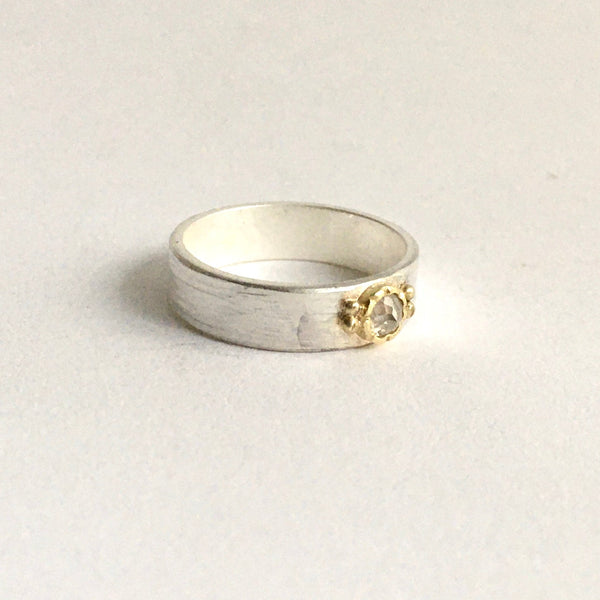 Side view of light grey rose cut diamond set in 18 ct gold bezel (hammer setting) on top of a 5 mm wide silver band - www.wyckoffsmith.com