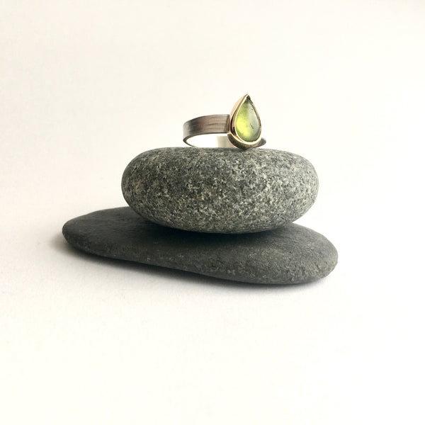 Pear shaped green idiocrase ring on top of two pebbles on www.wyckoffsmith.com