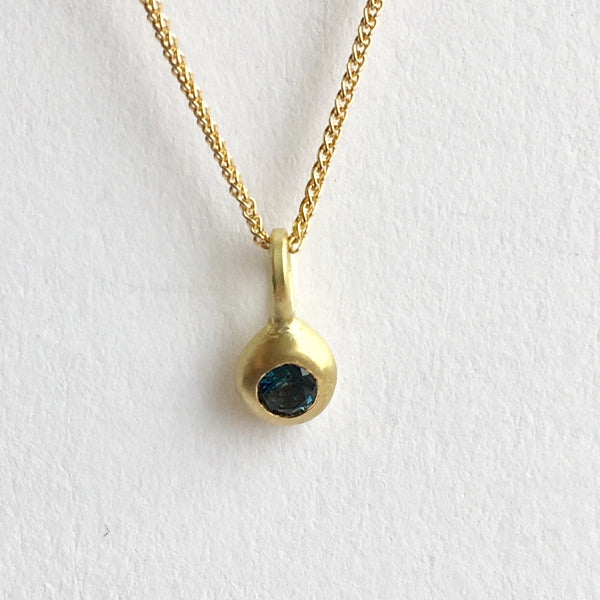 Front view of London Blue Topaz set into 18 ct gold pendant by Wyckoff Smith Jewellery