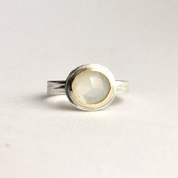 Front view of white moonstone set in 18 ct gold on silver textured band by Michele Wyckoff Smith on www.wyckoffsmtih.com stacking rings