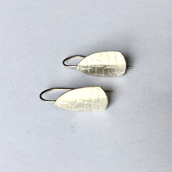 Side view of spinnaker earrings with overall irregular grid texture (option 1) on www.wyckoffsmith.com