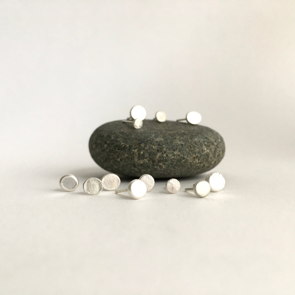 Assorted small single textured earrings on grey pebble - www.wyckoffsmith.com