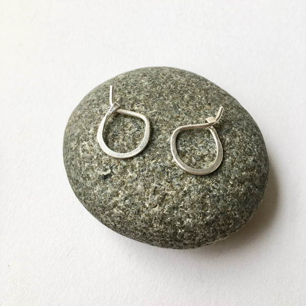 Small hand forged silver hoop earrings on a stone - Wyckoff Smith Jewellery