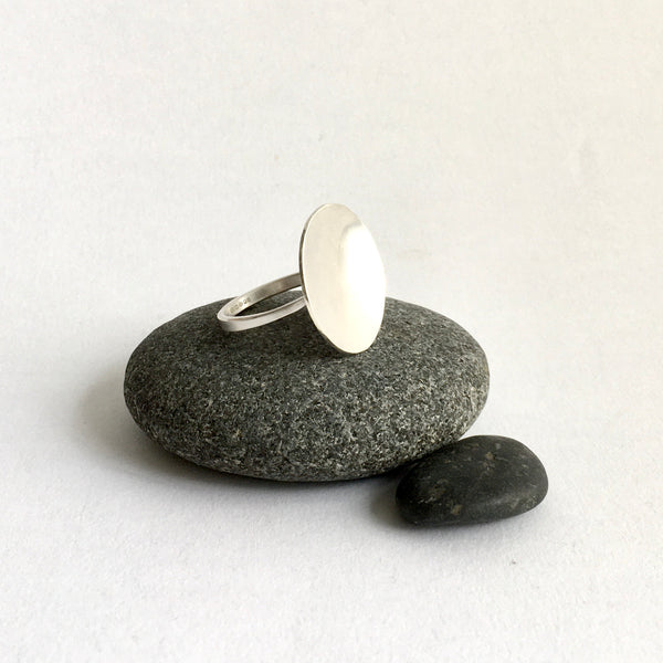 Side view of Lunar Ring on pebbles - www.wyckoffsmith.com - organic shaped silver ring