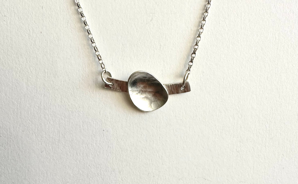 Textured silver oval on a hammered silver line - adjustable necklace length on belcher chain - www.wyckoffsmith.com