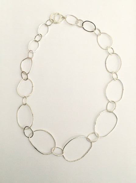 Long view of organic shaped silver pebble chain on www.wyckoffsmith.com