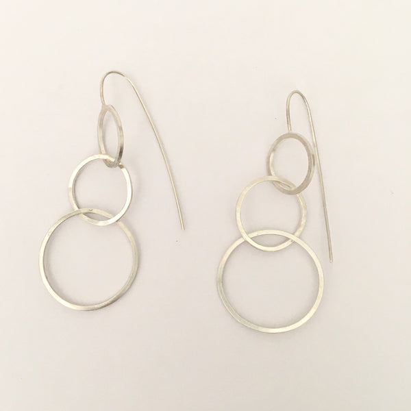 Three intertwined silver circle dangle earrings on www.wyckoffsmith.com