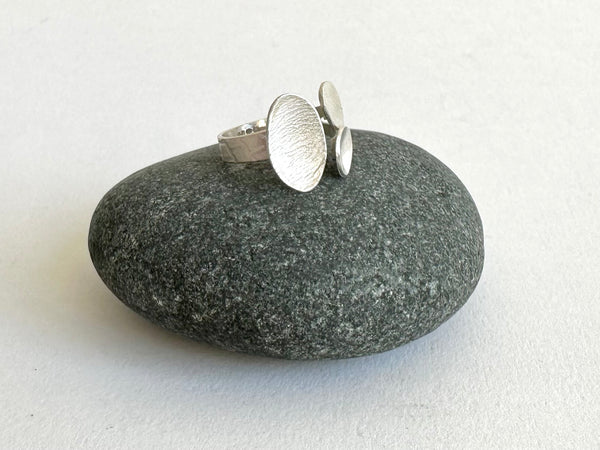 Side view of small adjustable ring with textured ovals and woven texture ring shank - www.wyckoffsmith.com